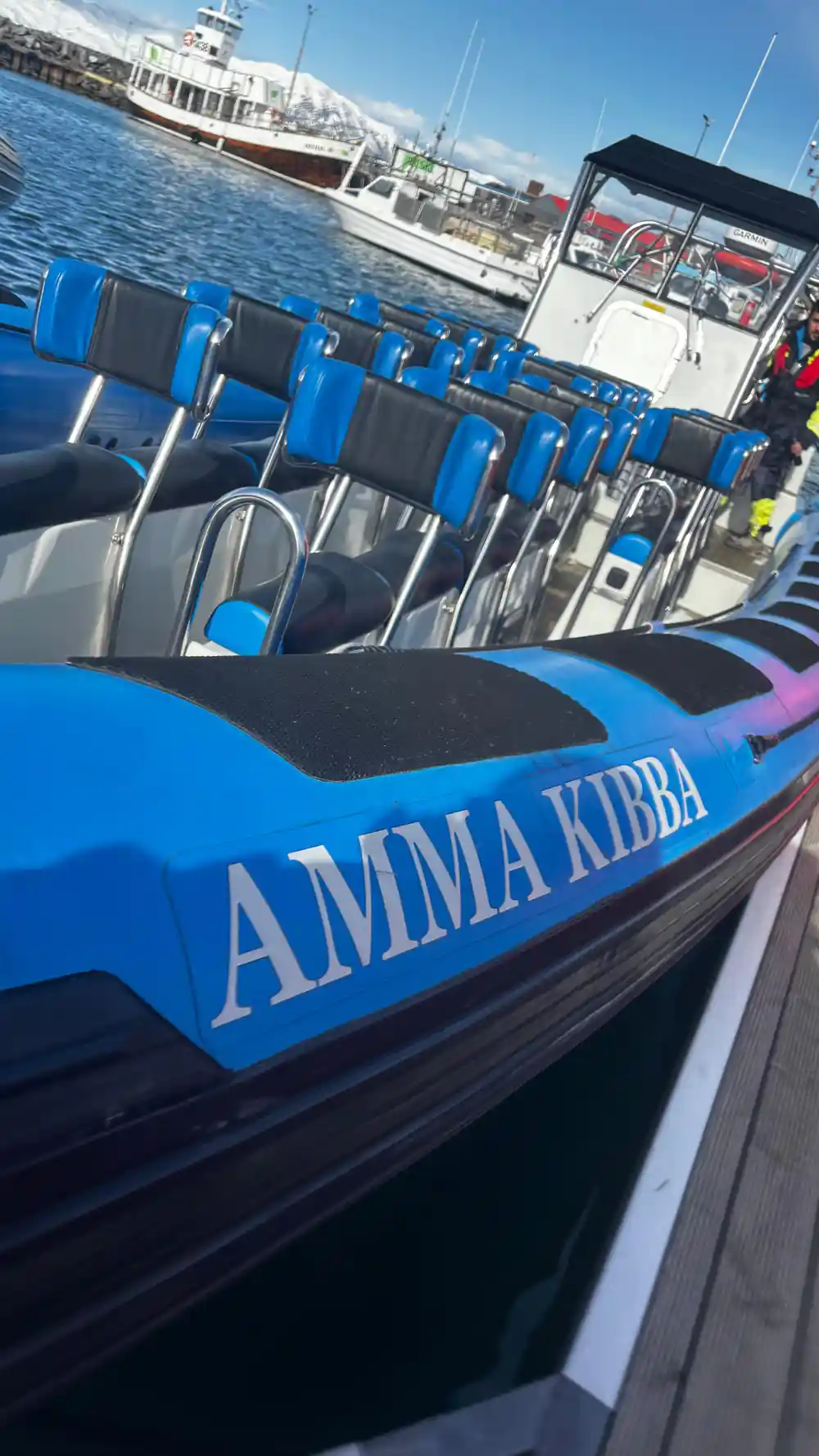 Blue speedboat named Amma Kibba docked at harbor
